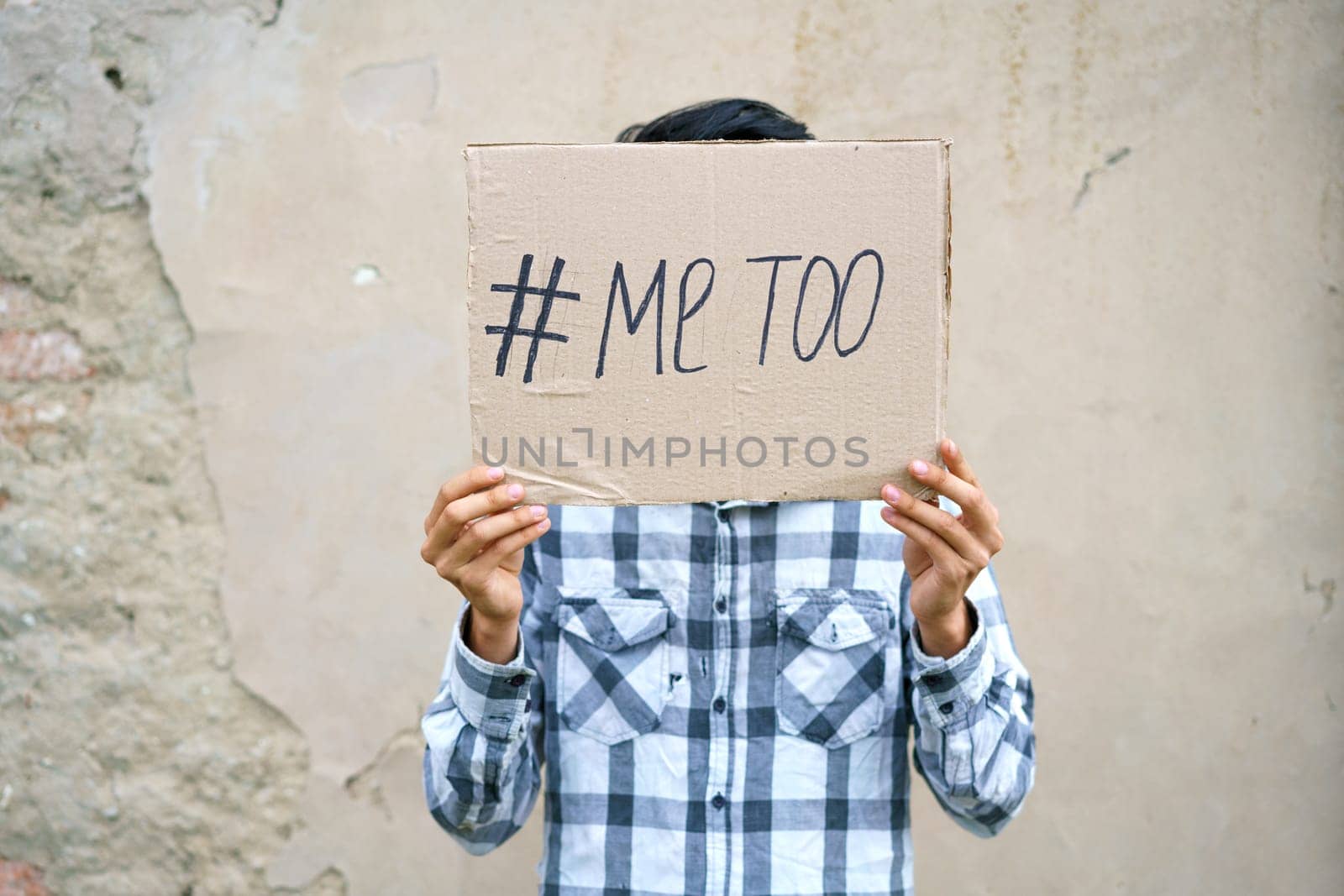 Men alone with depressed expression and showing a paper with a metoo text. Metoo as a new movement. Ideas to stop violence against , sexual harassment and rape, human trafficking