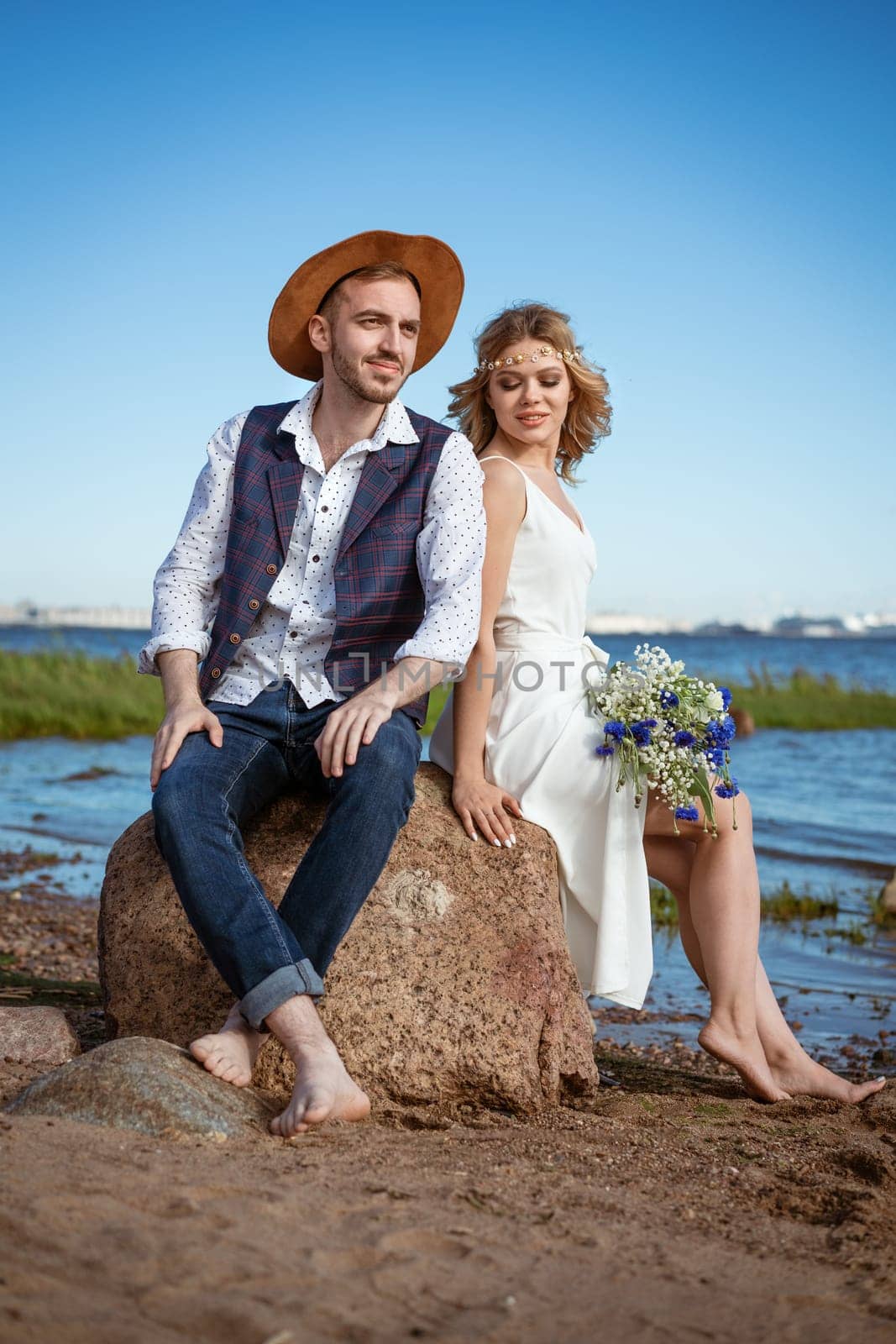 happy couple on the beach with a bouquet of flowers by EkaterinaPereslavtseva