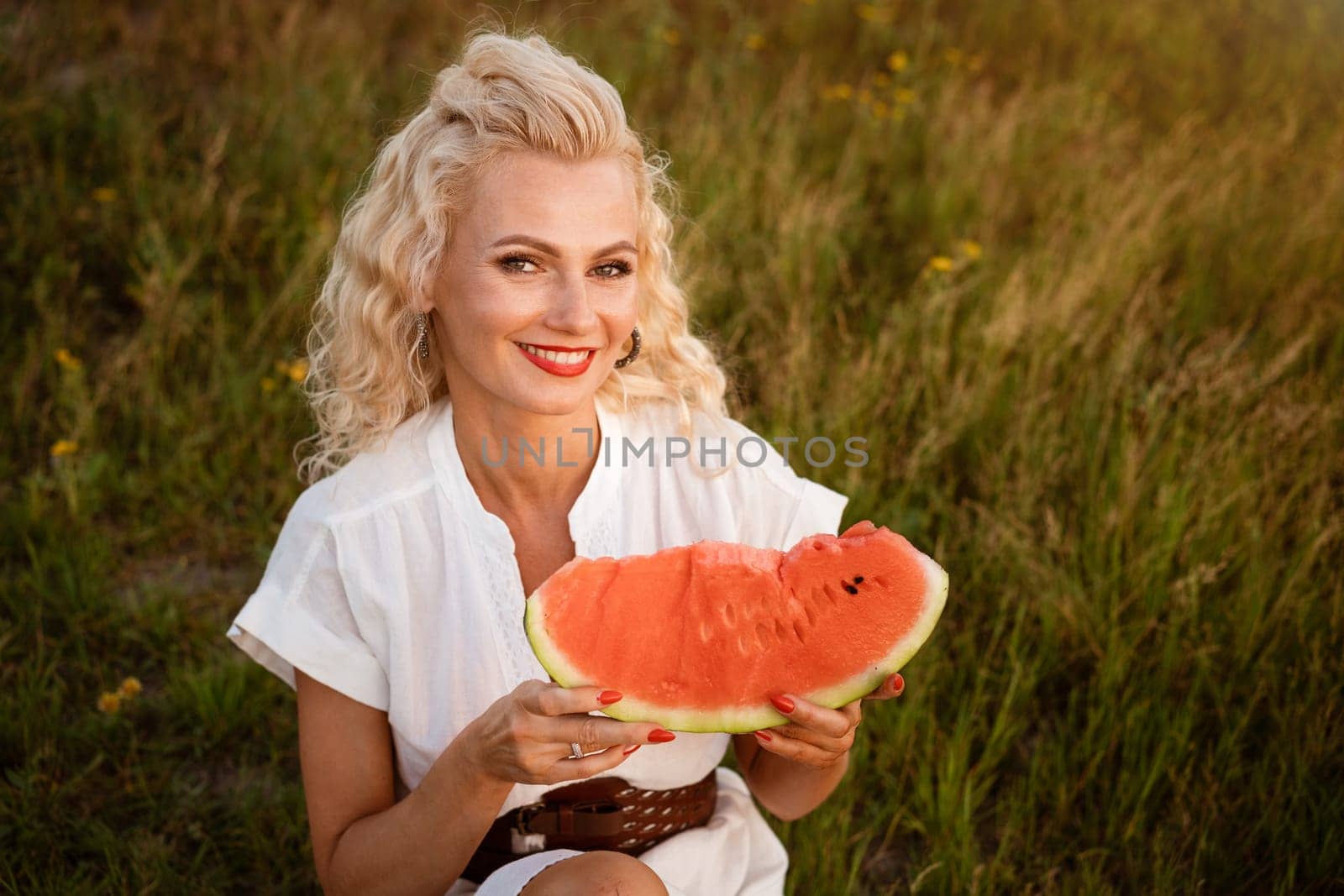 Portrait of a cute woman with a piece of watermelon in her by EkaterinaPereslavtseva