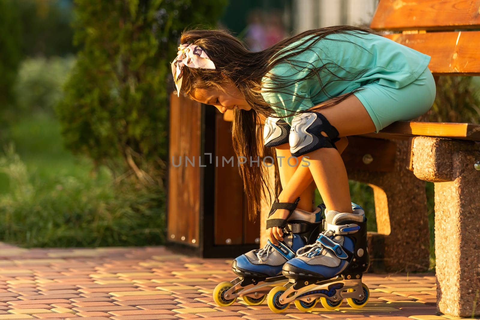 Little girl in roller skates at a park. by Andelov13