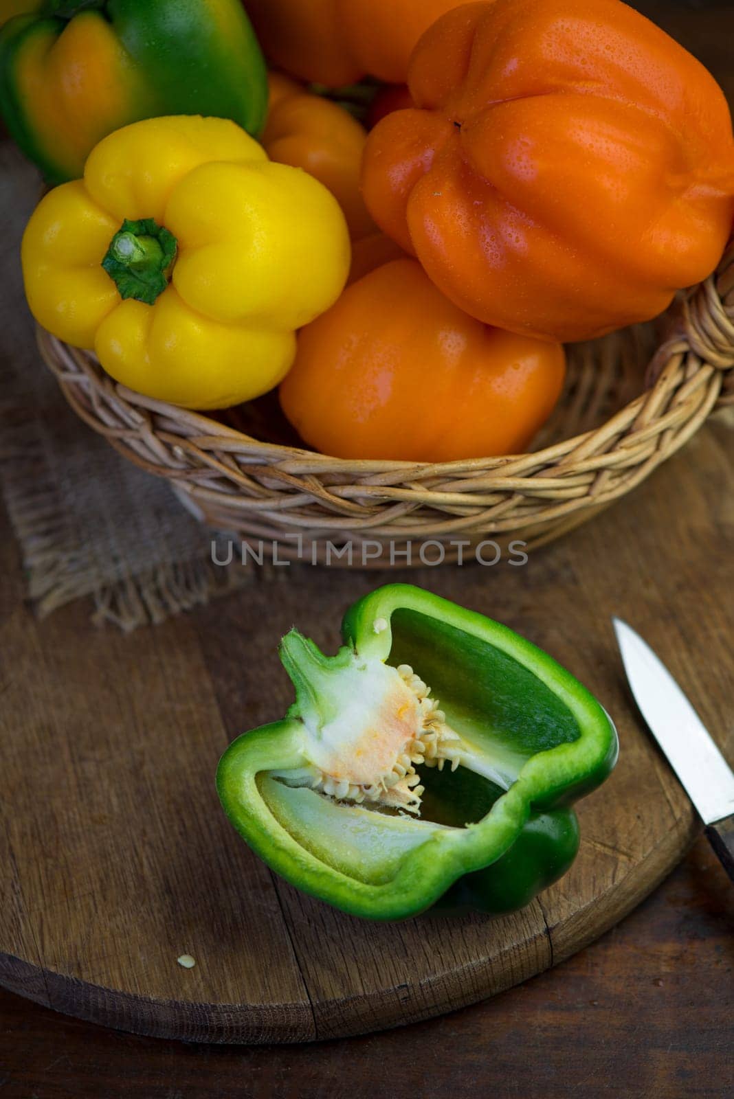 colored peppers on wooden board