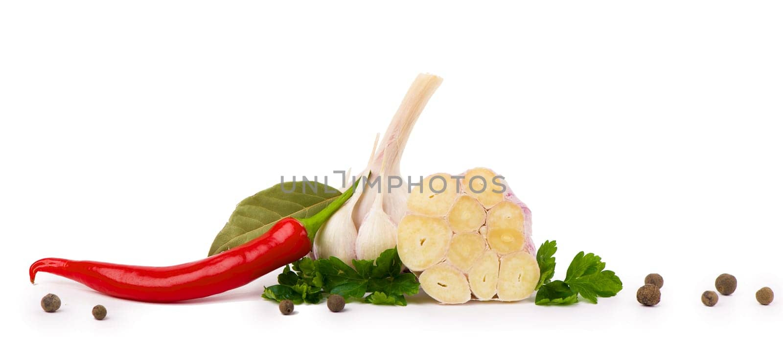 cut garlic on white background Head of young garlic with garlic cloves and parsley leaf isolated on white background.