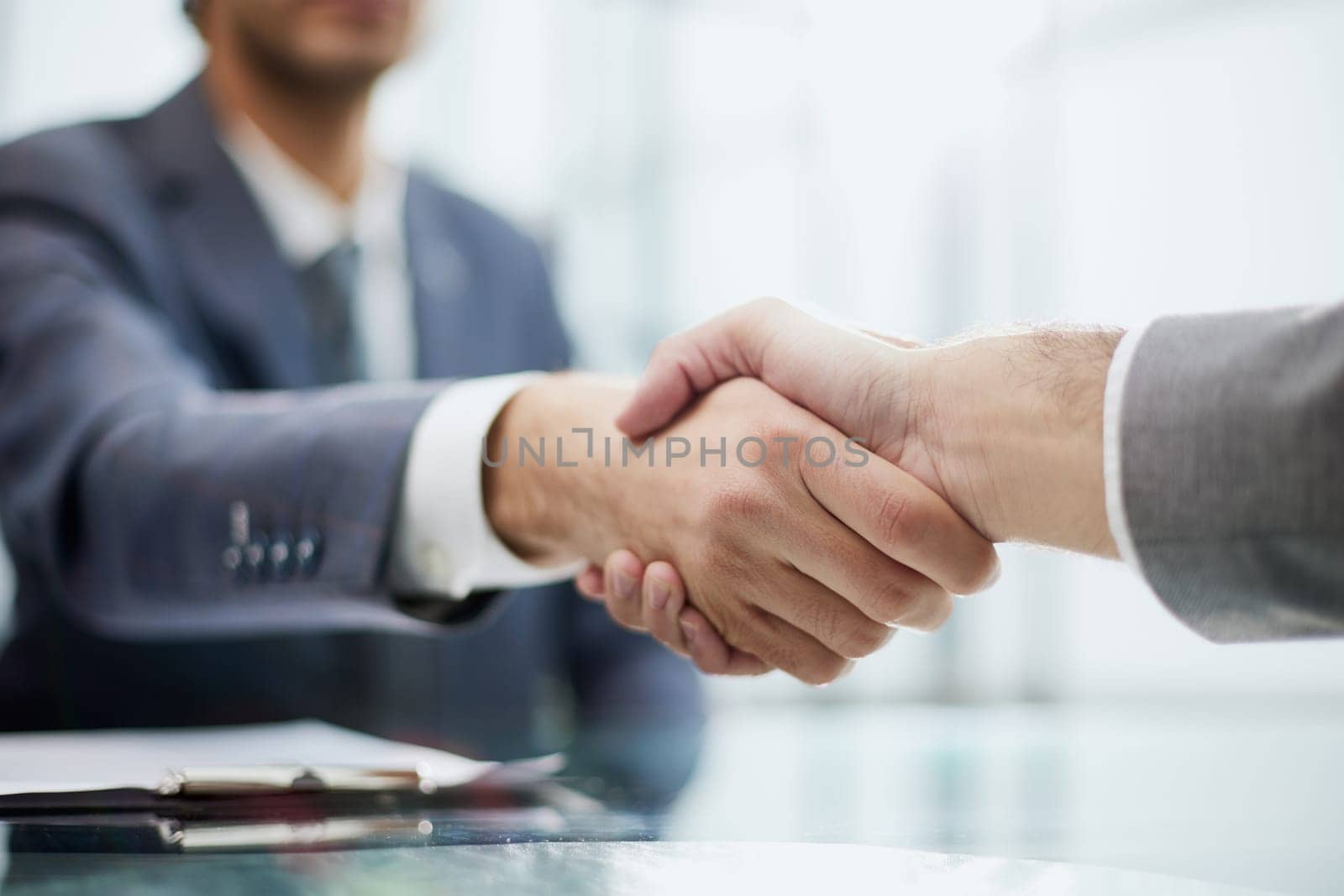 young businessman shaking hands with his partner