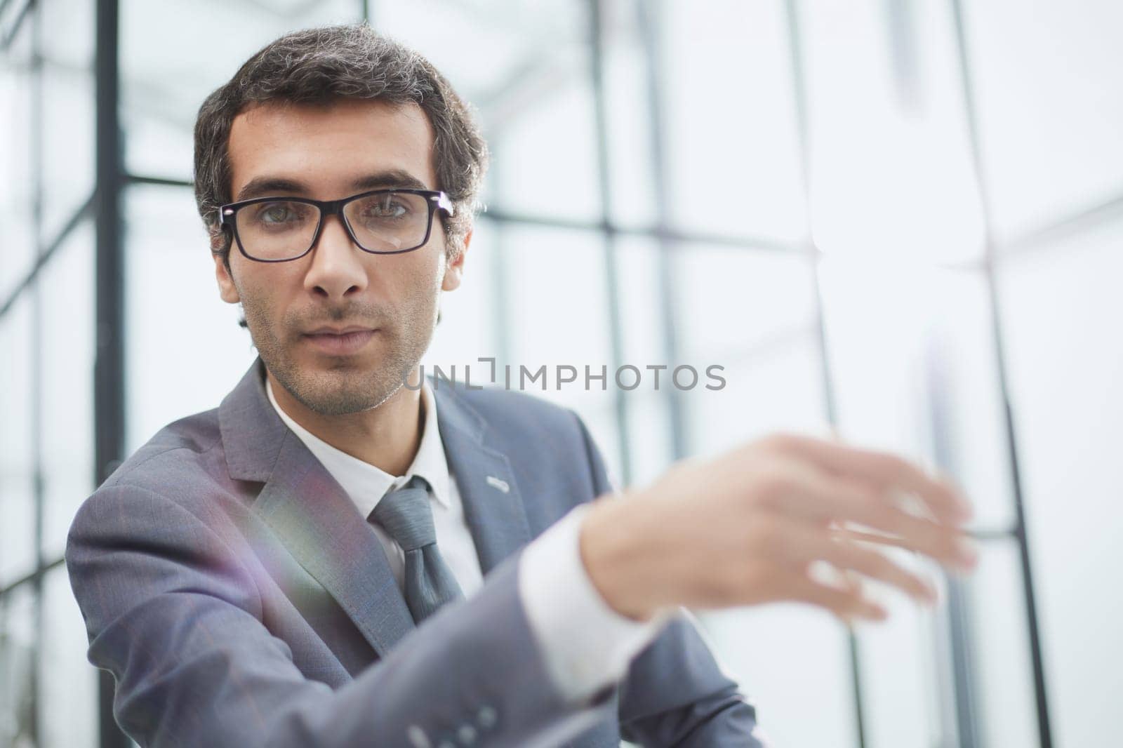 Headshot portrait 30s Caucasian millennial man in glasses sit at desk.