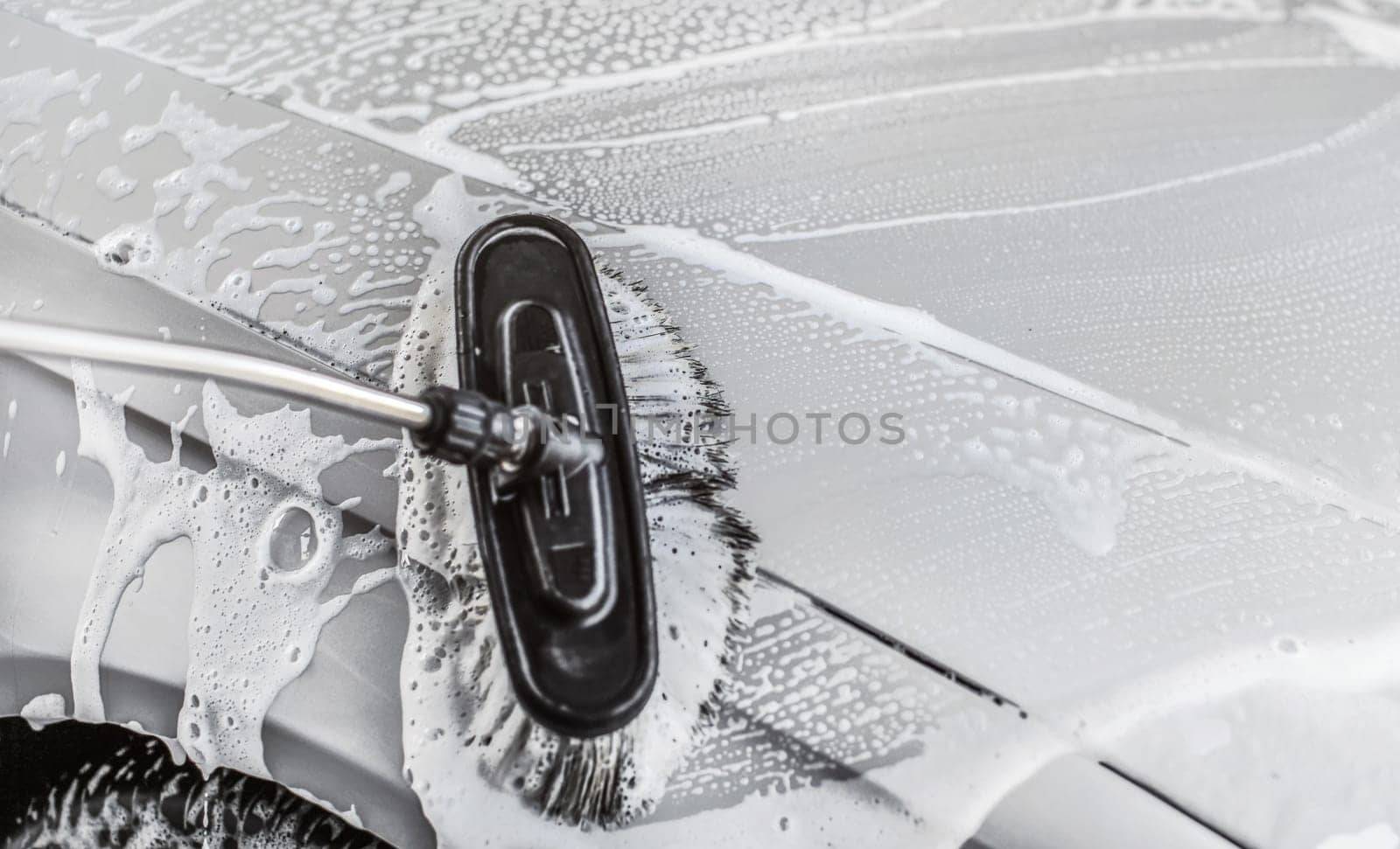 Detail on brush wet from shampoo, cleaning in carwash.