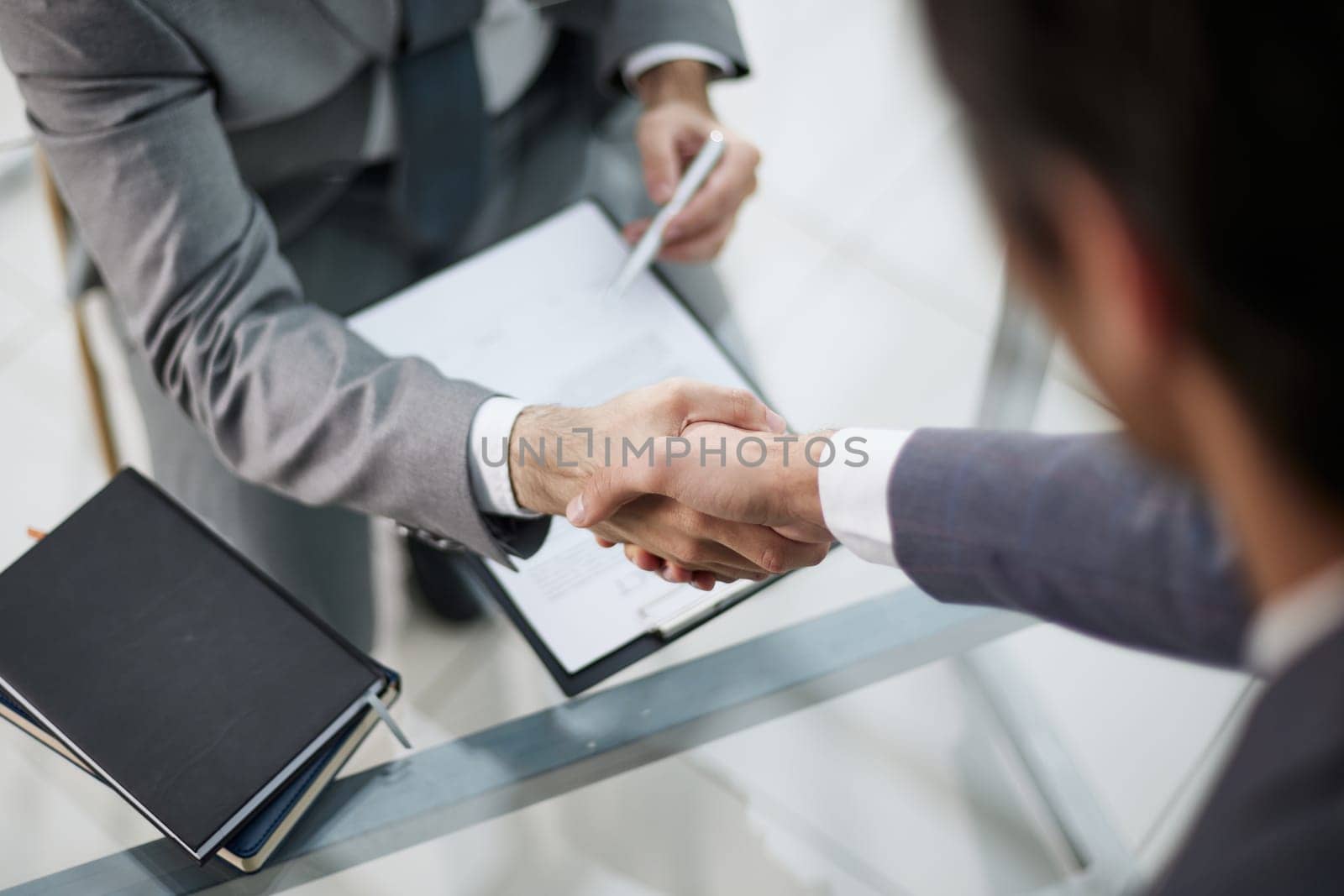 close up. handshake business people over the negotiating table.