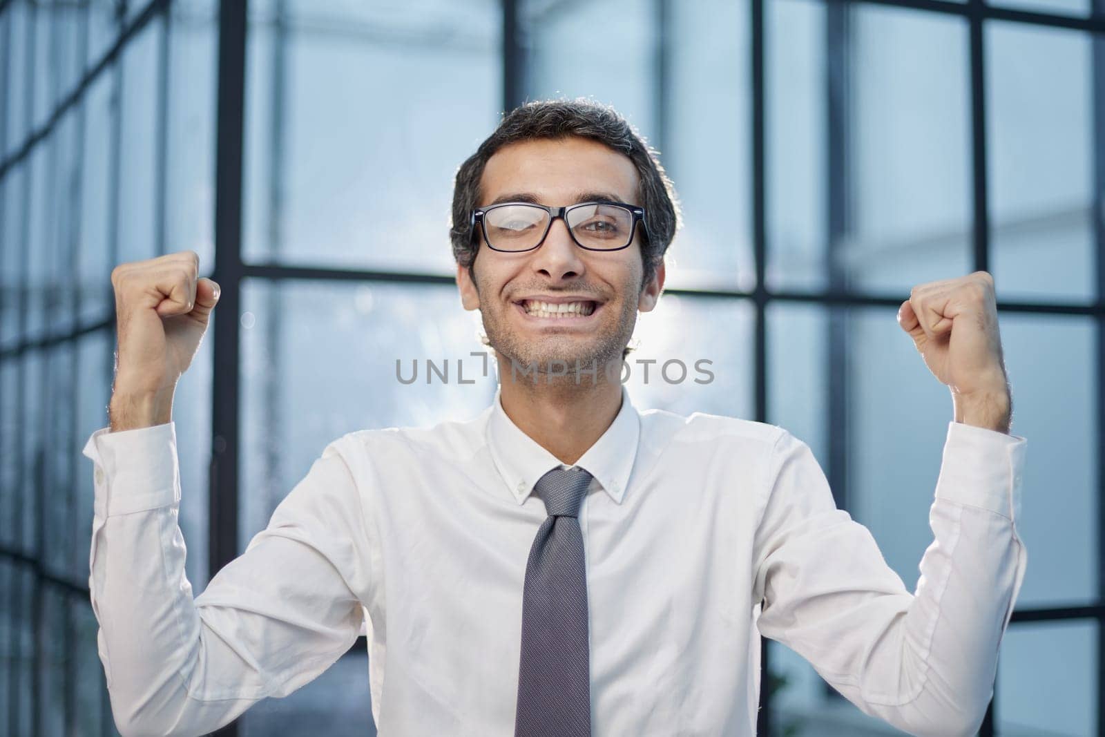 Millennial office worker standing in hallway clenched fists feel overjoyed celebrate career advancement