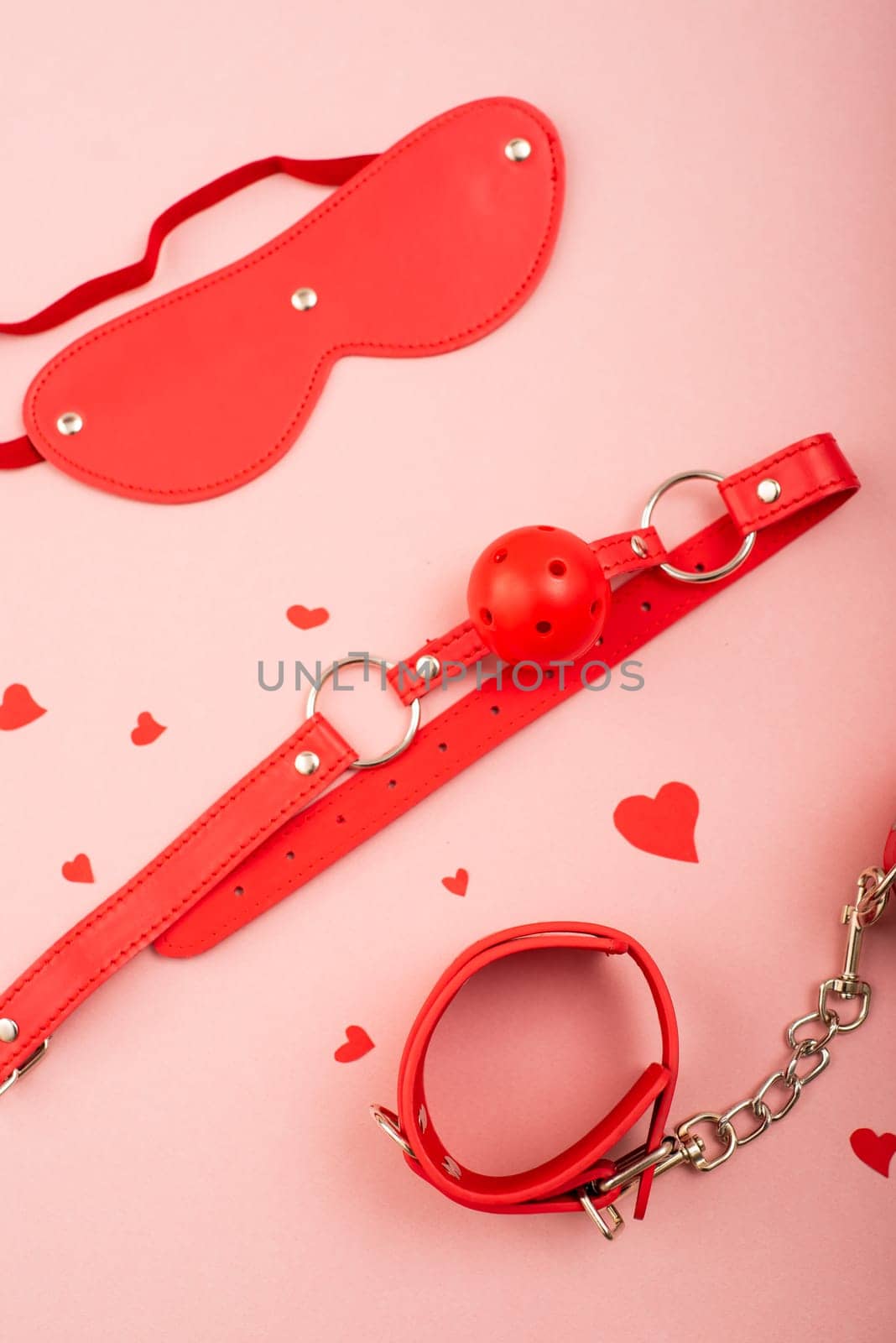 BDSM set in red on a pink background. Love symbol for valentine's day. by mrwed54