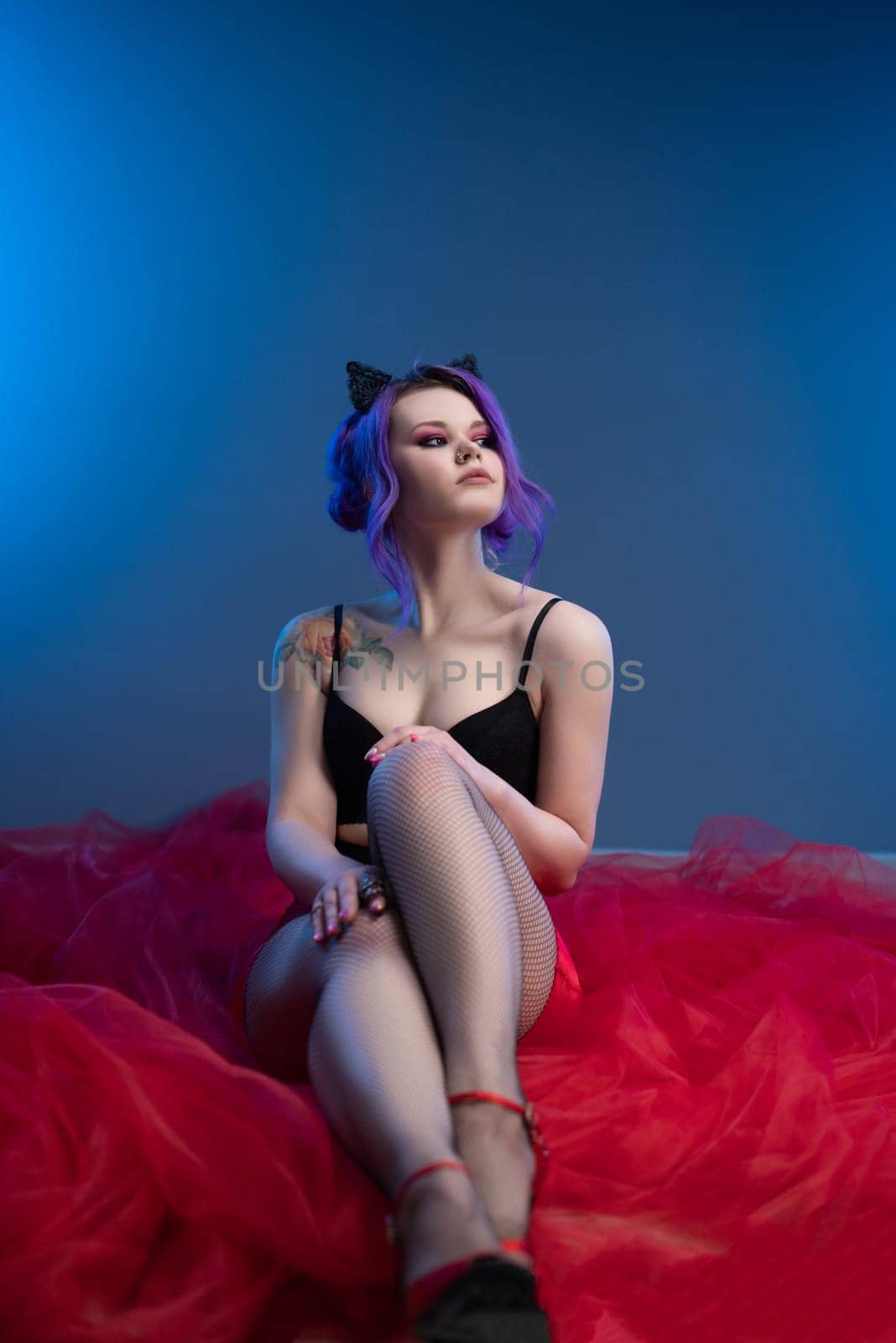 sexy girl posing erotically with a transparent red fabric on a blue background by Rotozey