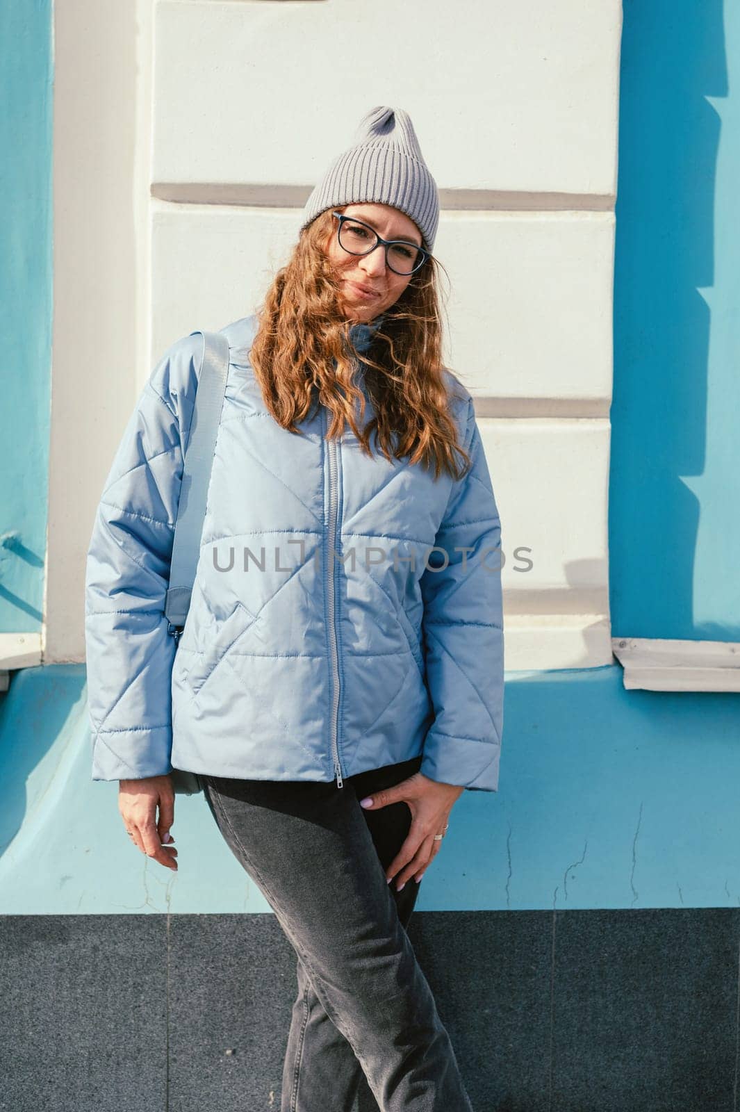 Portrait of a stylish woman in blue jacket. Spring outdoor portrait.