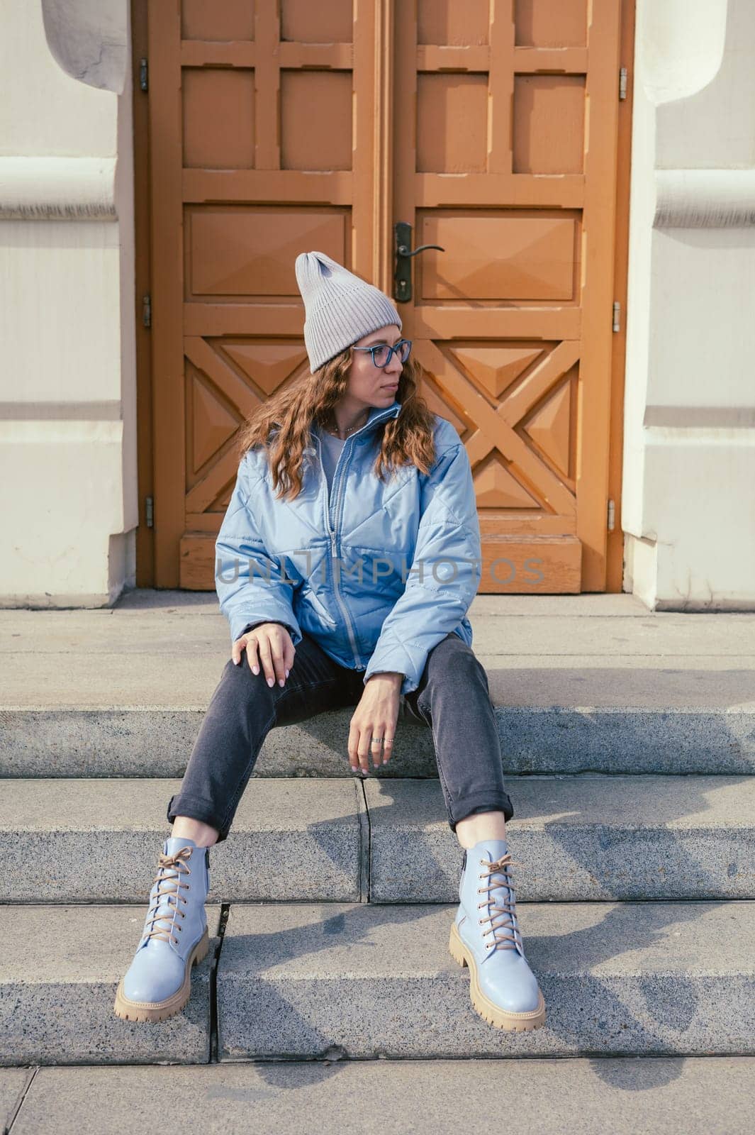 Portrait of a stylish woman in blue jacket. Spring outdoor portrait.