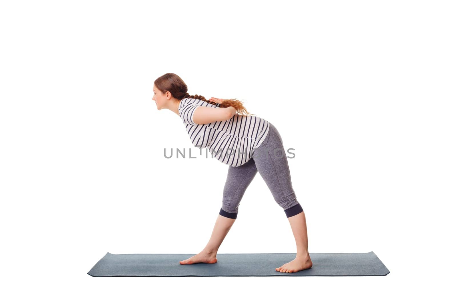 Pregnant woman doing yoga asana parsvottanasana isolated by dimol