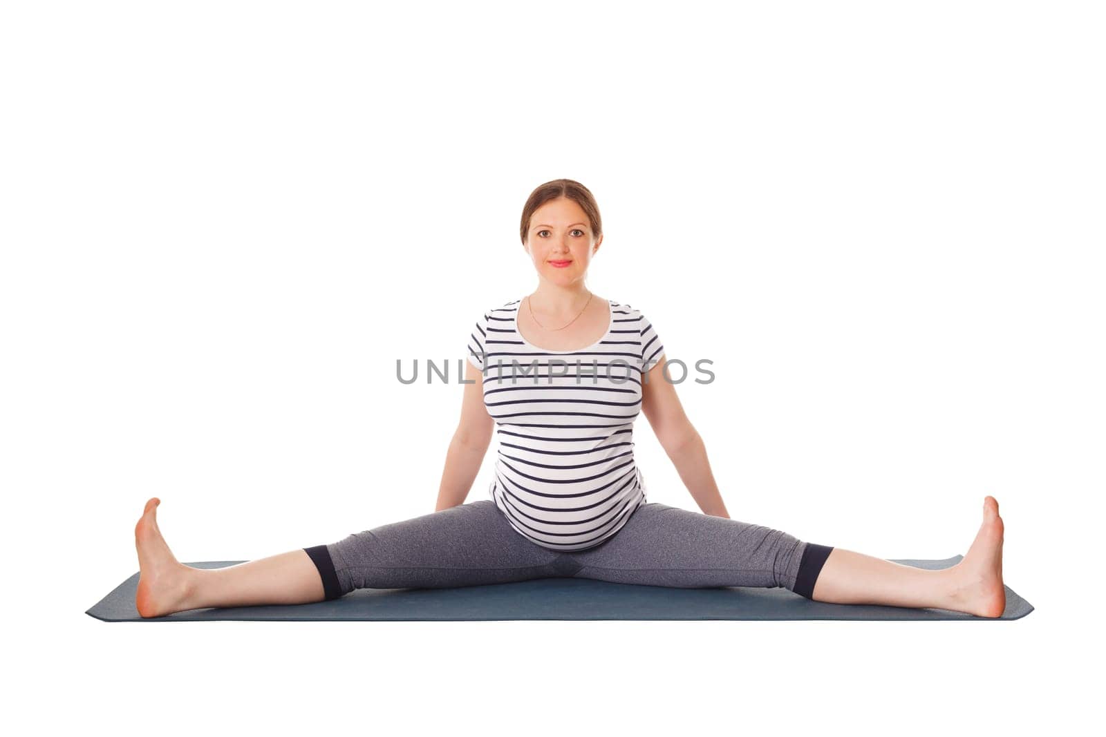 Pregnant woman doing yoga asana Upavistha Konasana by dimol