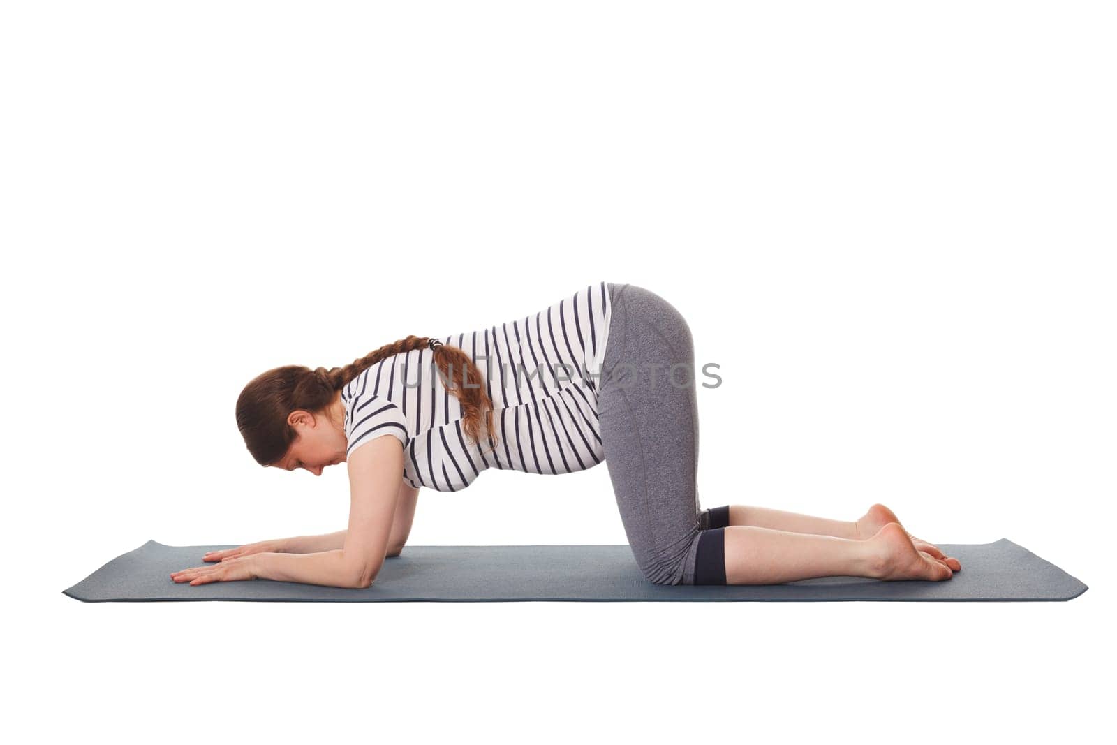 Pregnant woman doing yoga asana Balasana child pose by dimol