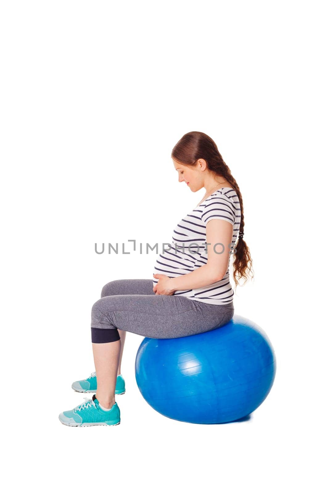 Pregnant woman doing exercises with exercise ball by dimol