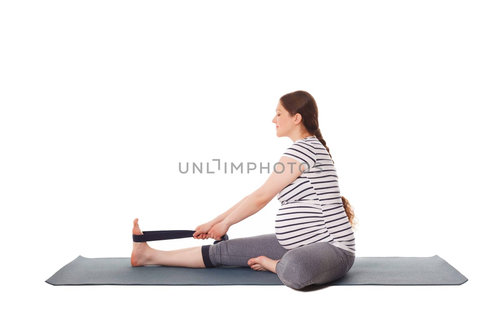 Pregnant woman doing yoga asana Janu Sirsasana A by dimol
