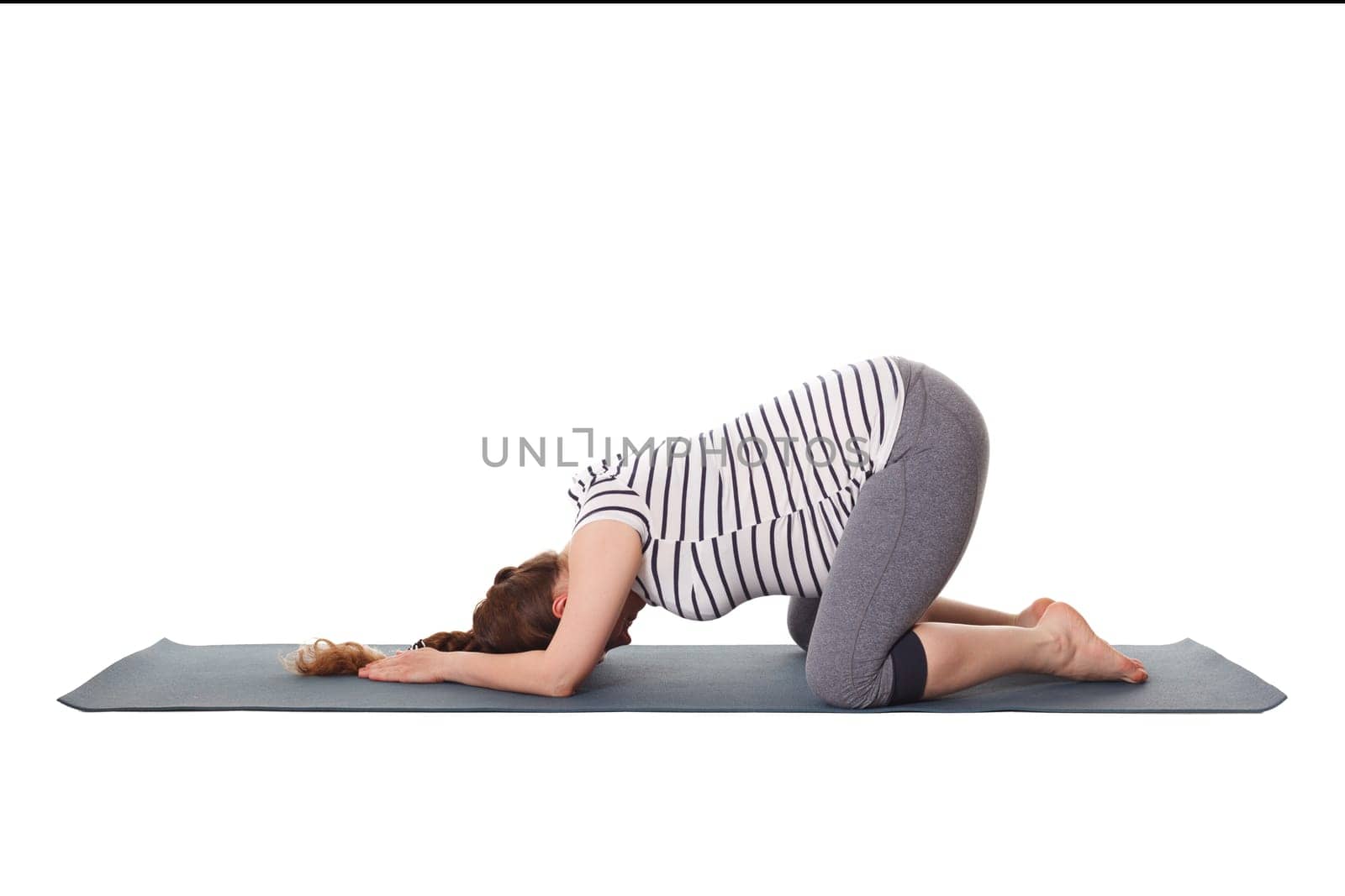 Pregnancy yoga exercise - pregnant woman doing asana Balasana - child s pose isolated on white background