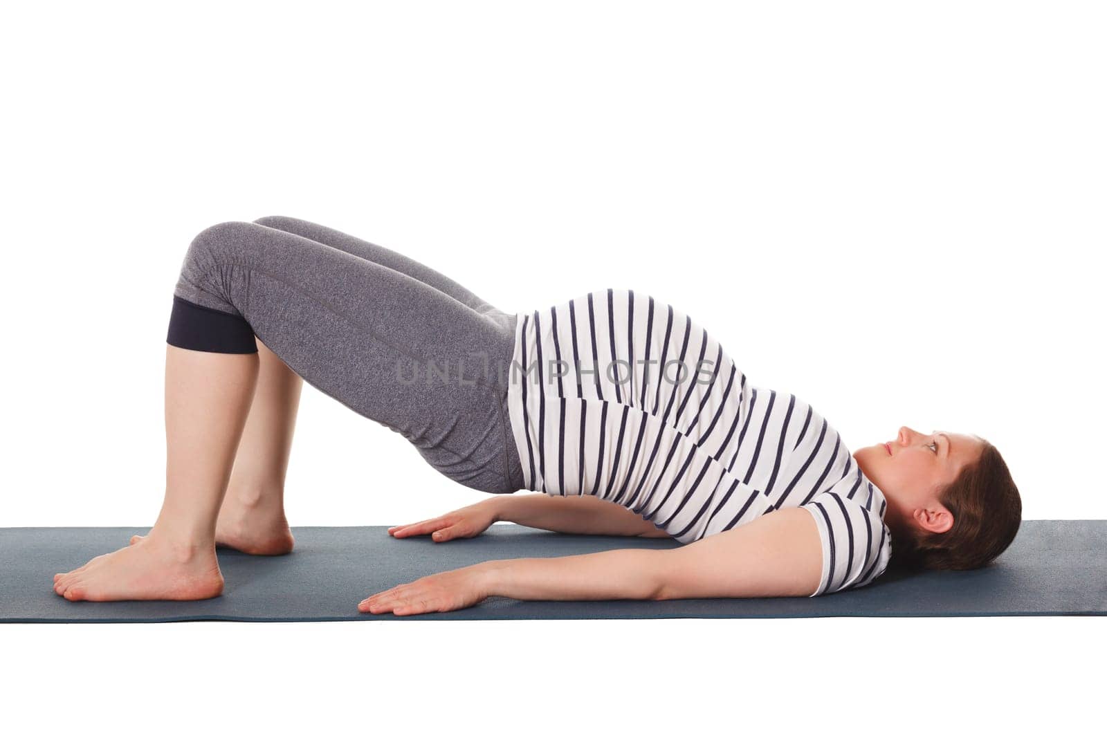 Pregnant woman doing yoga asana Purvottanasana by dimol