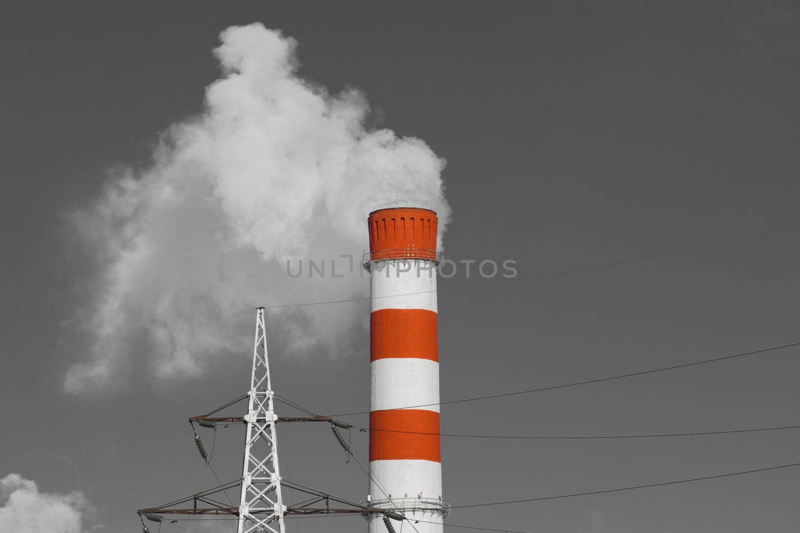 The pipe of the industrial plant emits toxic grey smoke into the atmosphere sky and air. Pollution of the environment and ecology. Thermal power plant power lines high voltage by AYDO8