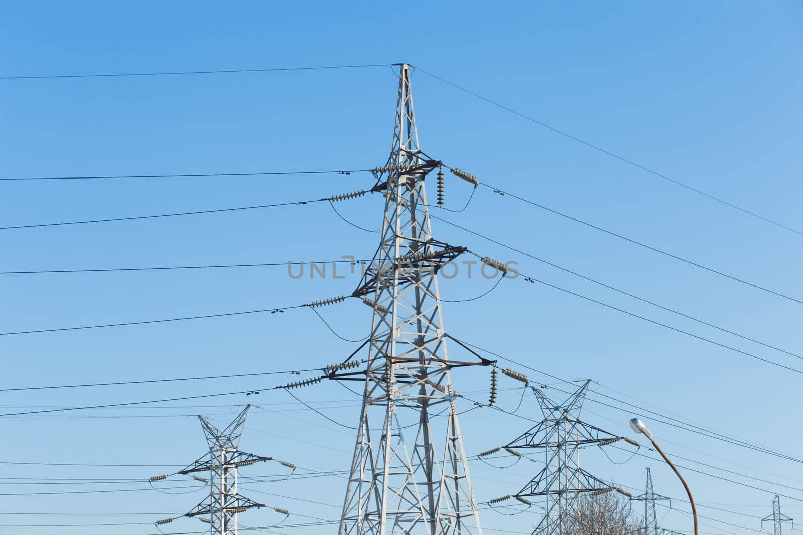 Electricity voltage high energy power technology electrical tower industry line electric blue sky.