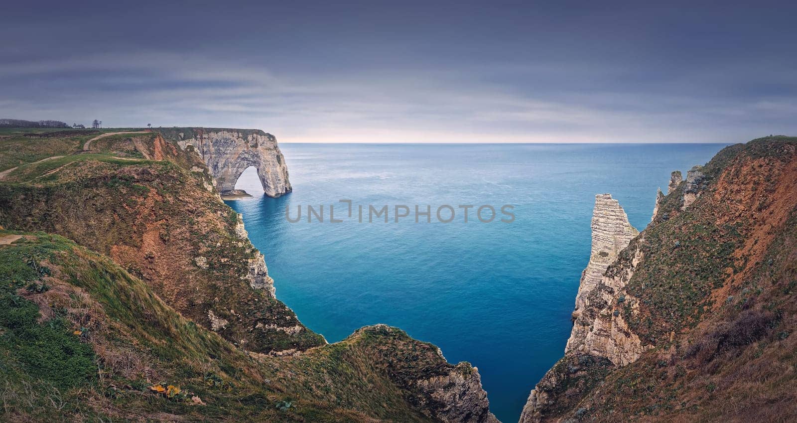 Beautiful panorama of the Porte d'Aval natural arch at Etretat famous cliffs, Normandy, France