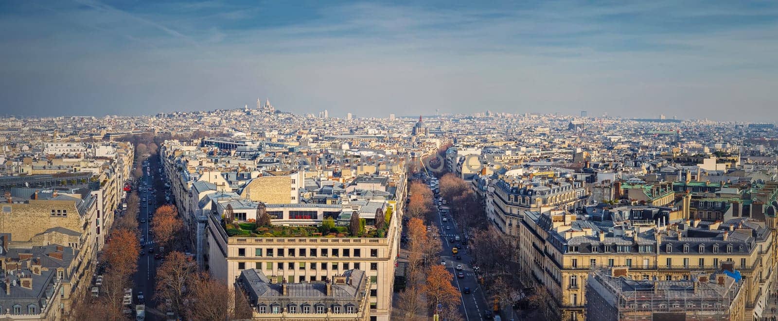 Aerial Paris cityscape panorama with view to Sacre Coeur Basilica of the Sacred Heart, France. Beautiful parisian architecture, historic buildings and landmarks on the horizon