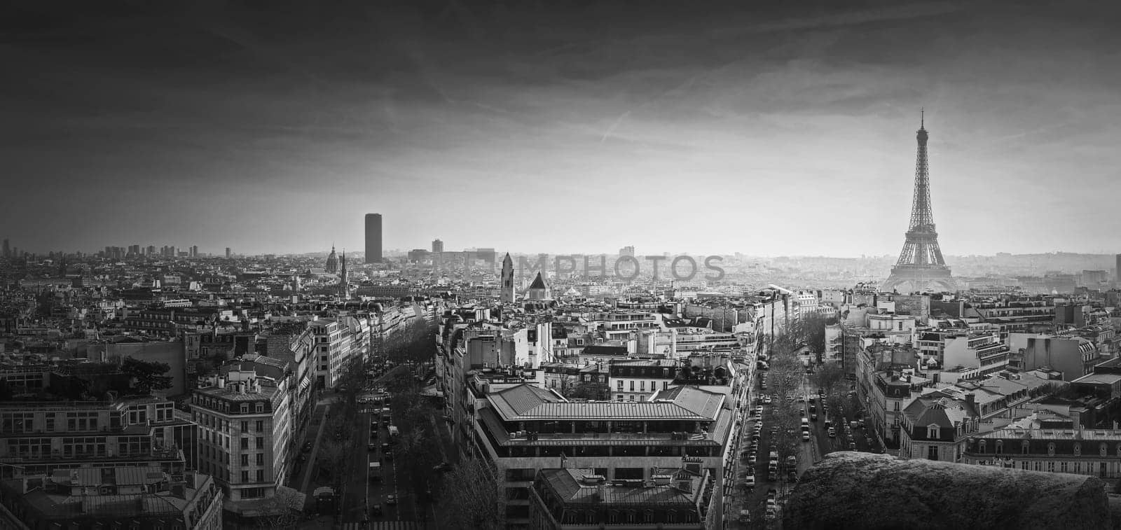 Black and white Paris panorama. Romantic aerial view over rooftops to the Eiffel Tower, France. Holiday destination, sightseeing parisian cityscape scene, historic landmarks on the horizon by psychoshadow