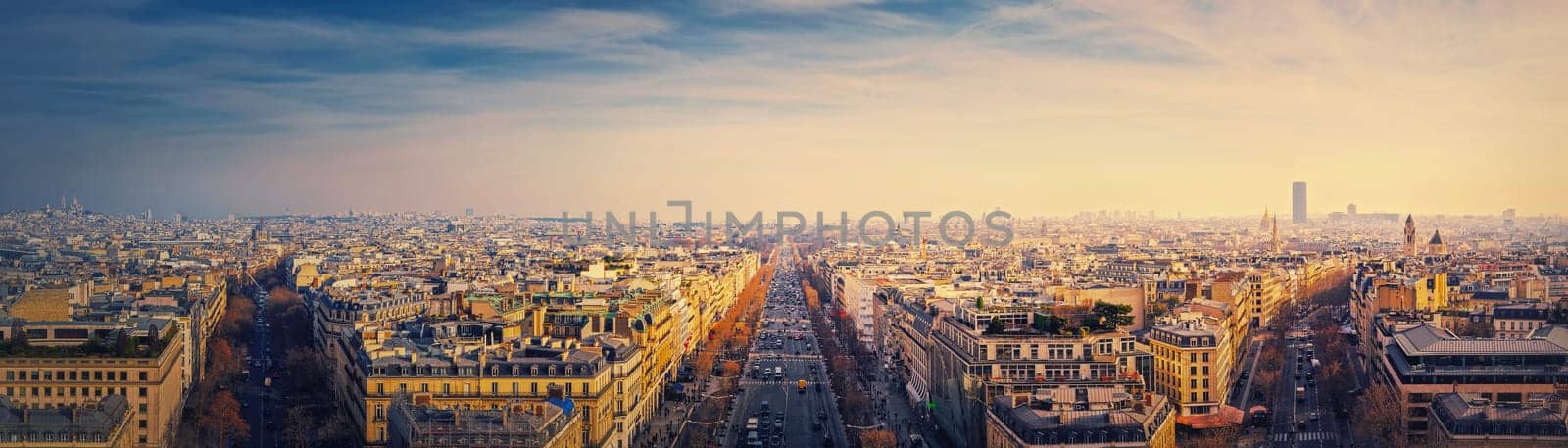 Paris cityscape sunset panorama from the triumphal arch with view to parisian avenues and Champs-Elysee in the center. Beautiful architectural landmarks on the horizon