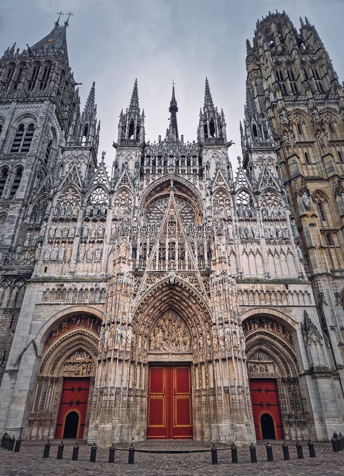 Outdoor facade view of Notre Dame de Rouen Cathedral in the Normandy, France. Architectural landmark featuring styles from Early Gothic to late Flamboyant and Renaissance architecture