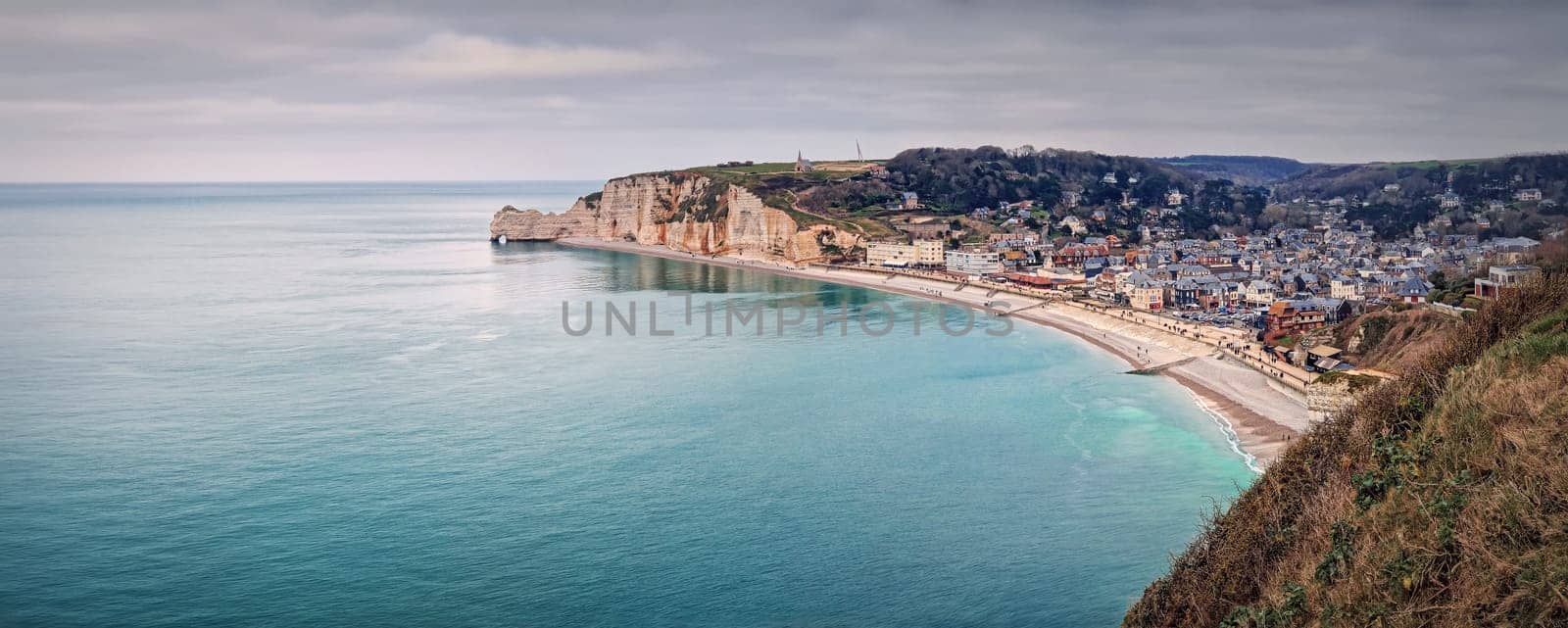 Wonderful panoramic view to the Etretat village and beach resort from the famous Falaise d'Aval cliffs in Normandy, France