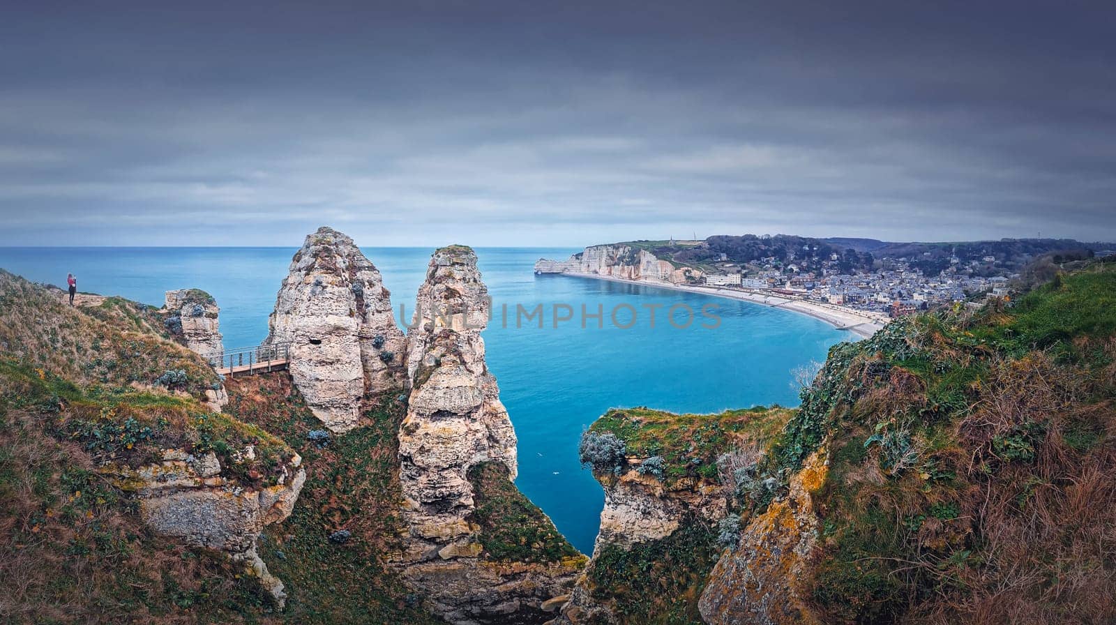 Beautiful panoramic view to the Etretat village and beach resort from the famous Falaise d'Aval cliffs in Normandy, France