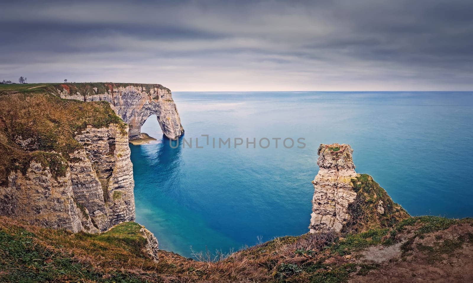 Beautiful view to the Porte d'Aval natural arch at Etretat famous cliffs in Normandy, France by psychoshadow