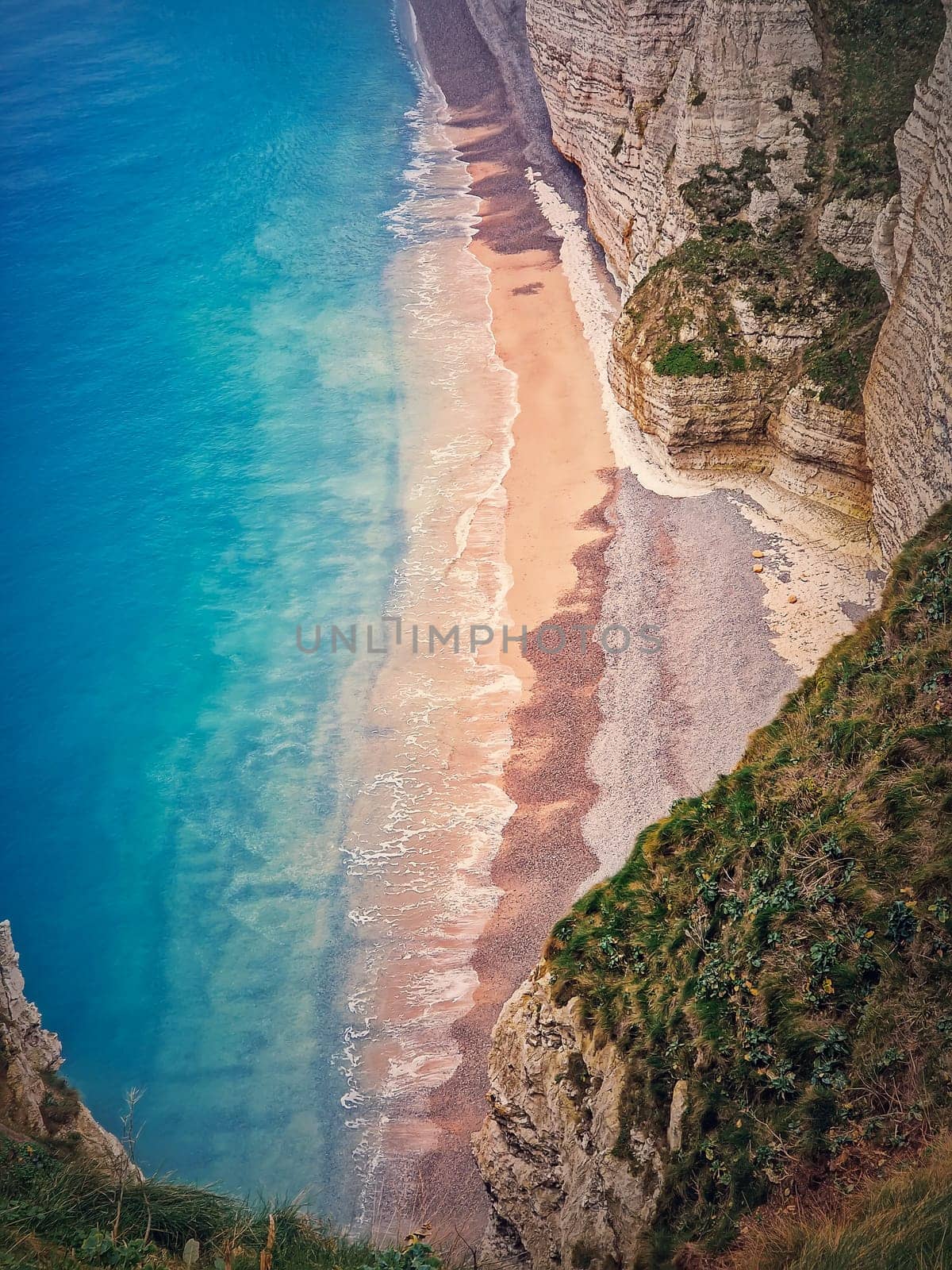 Tropical lagoon aerial view. A beach hidden behind the high cliffs and washed by the blue and clean ocean water. Summer seaside background by psychoshadow