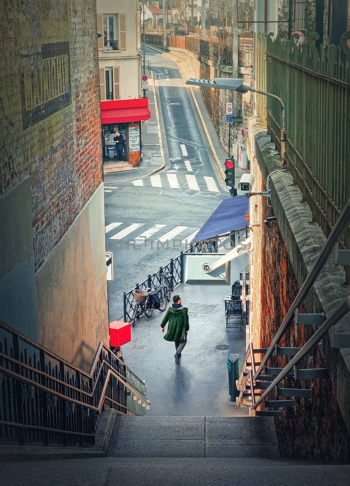 Outdoors scene with a man walking on the city streets in Asnieres sur Seine, a Paris suburb, France