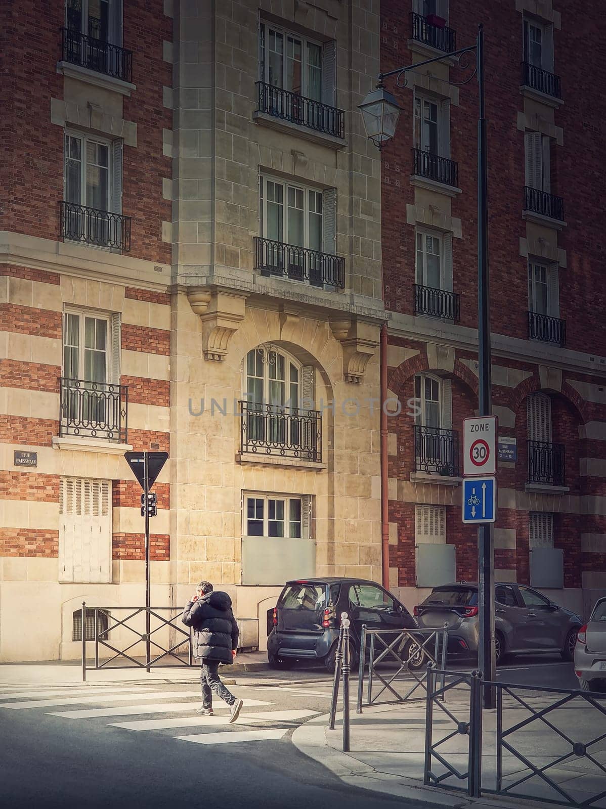 Outdoors scene with a person crossing the street on the crosswalk in Asnieres sur Seine, a Paris suburb, France by psychoshadow