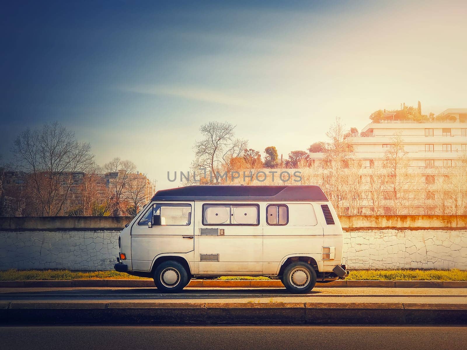 Old van parked on the edge of the street in the sunset sky background, Asnieres sur Seine, Paris suburb, France by psychoshadow