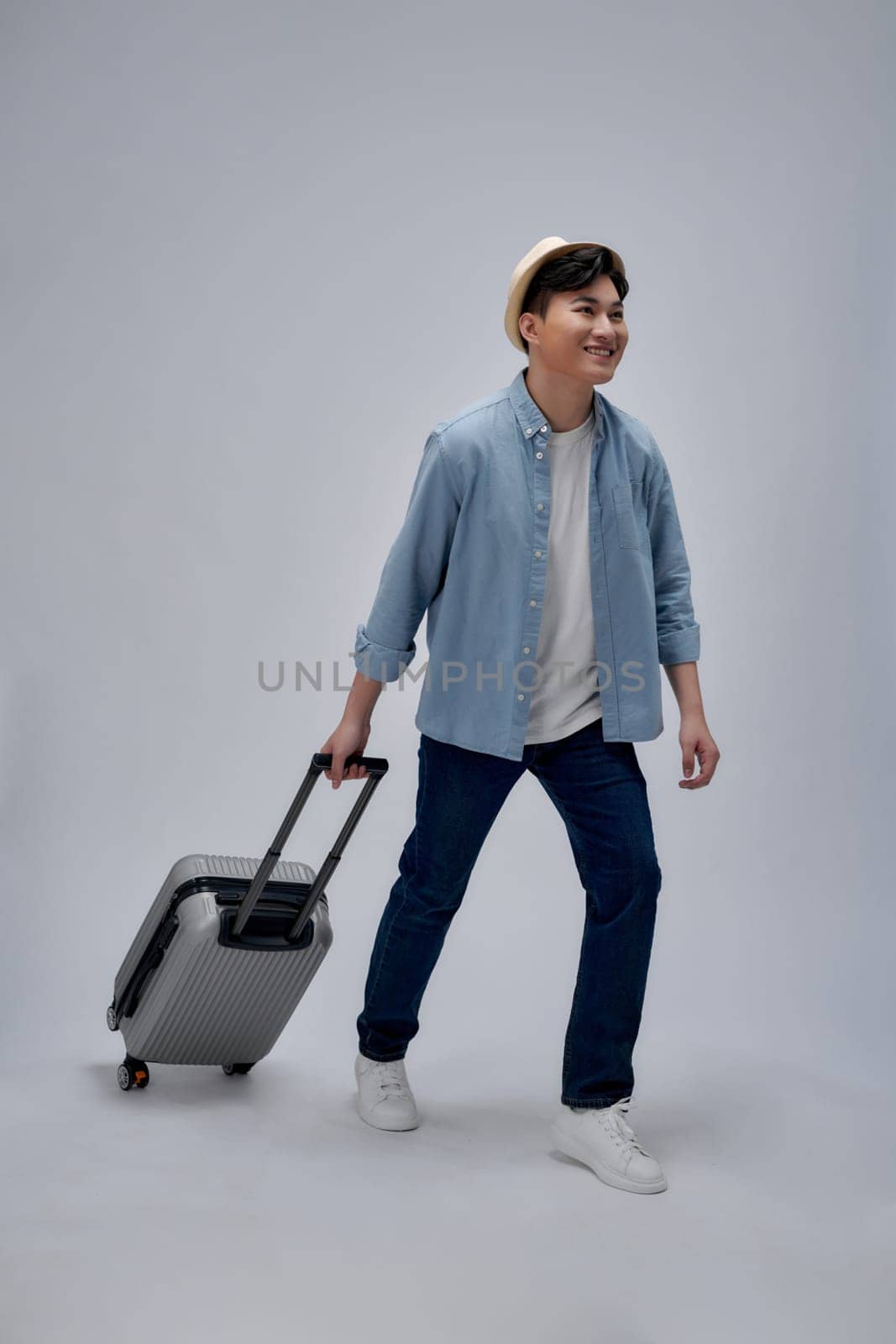 Full body photo of young man happy positive smile tourism holiday suitcase camera passport  by makidotvn