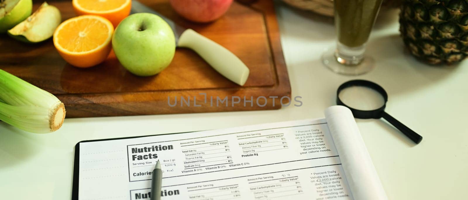 Fruit and vegetable on chopping board with Nutrition Facts on table. High quality photo
