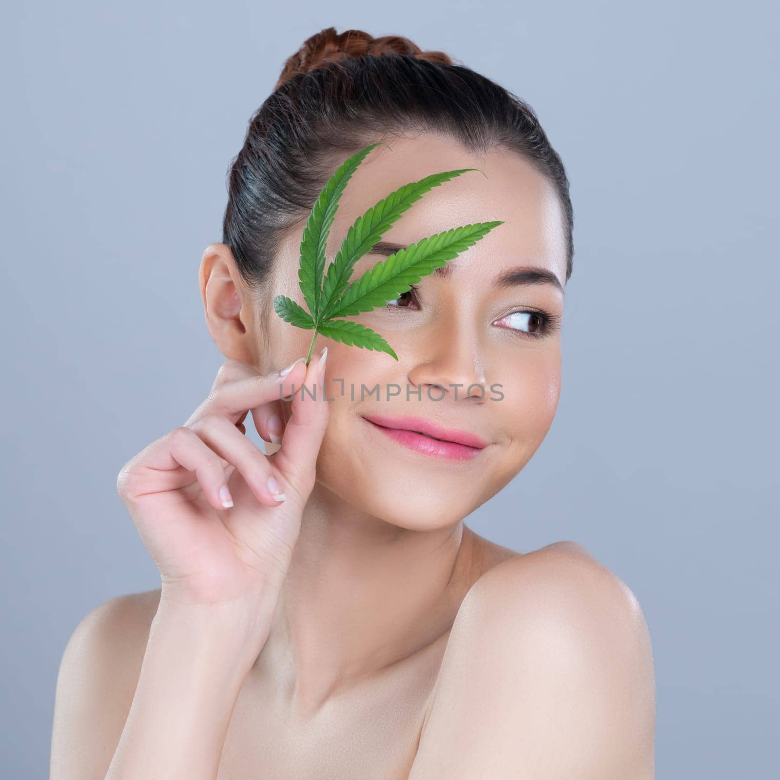 Closeup glamorous woman hold green leaf as cannabis beauty concept. by biancoblue