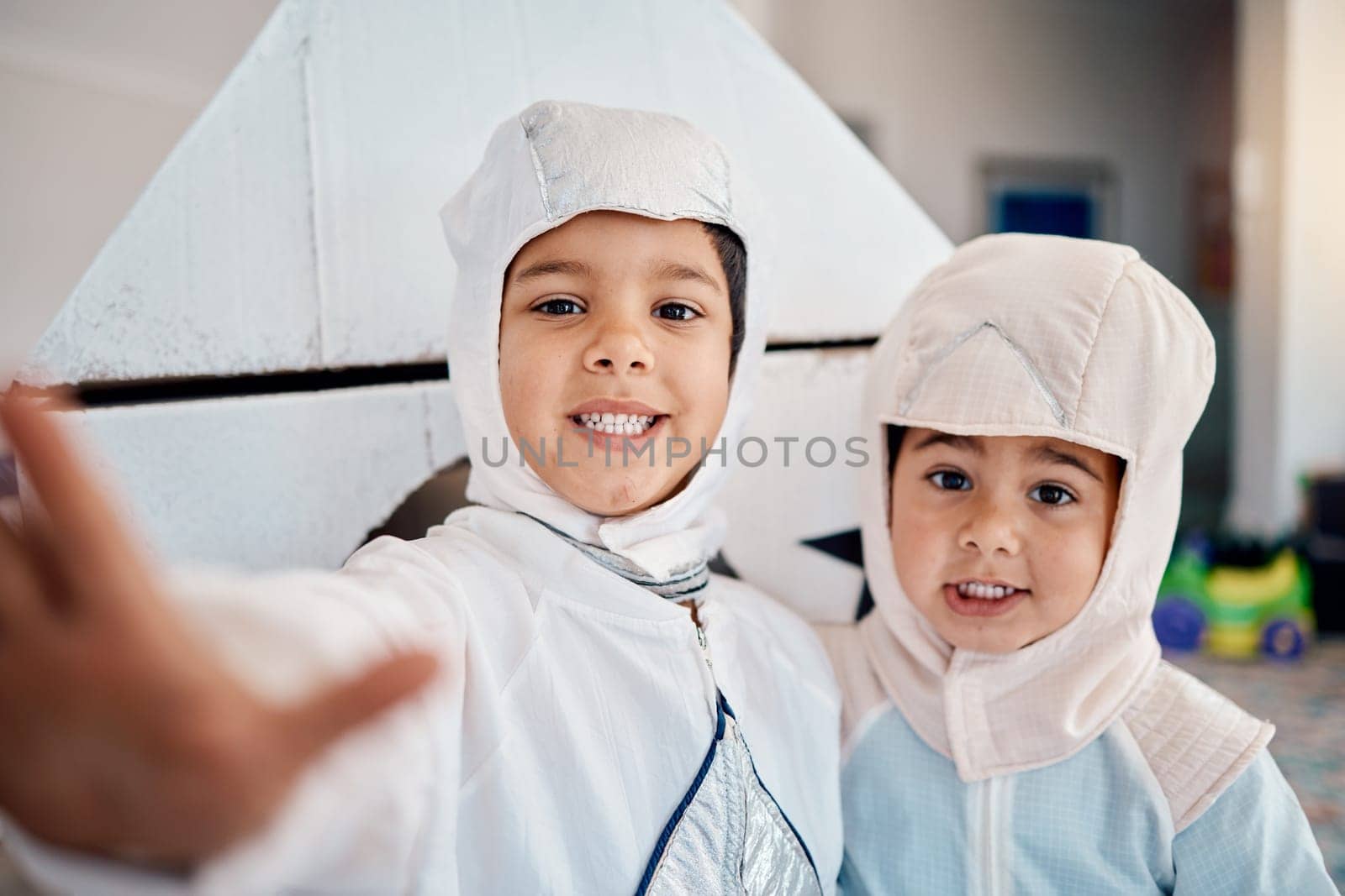Selfie, costume and playing with children at home for astronaut, halloween and fantasy. Happy, smile and picture with kids in spacesuit in play room for imagination, photography and siblings.