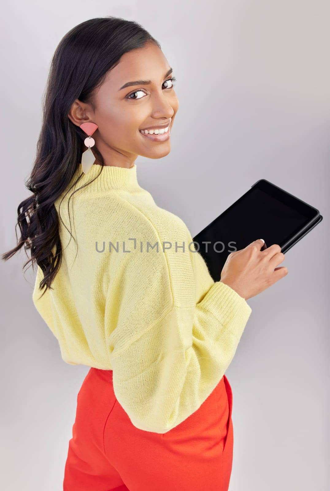 Happy, portrait and a woman with a tablet for an email, communication and the internet. White background, isolated and an Indian girl with technology for social media, business app and the web.