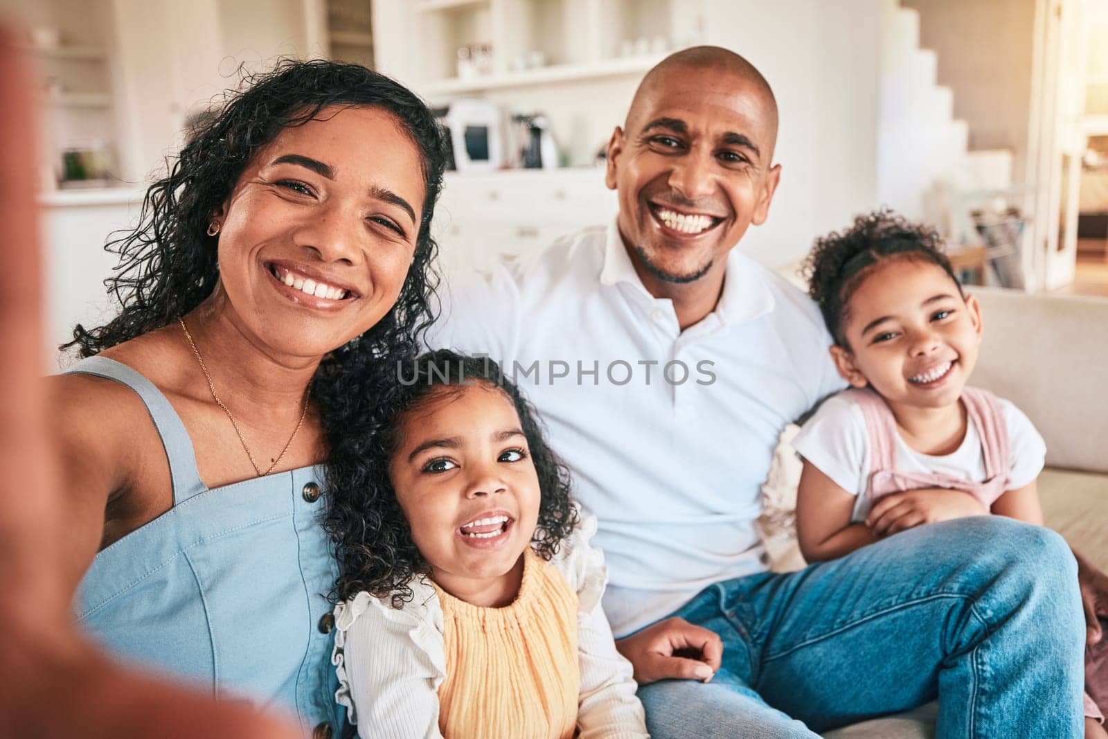 Happy family, portrait and smile for selfie, photo or profile picture on a sofa in their home. Love, face and photograph pf children with parents in a living room, excited and bonding on the weekend.