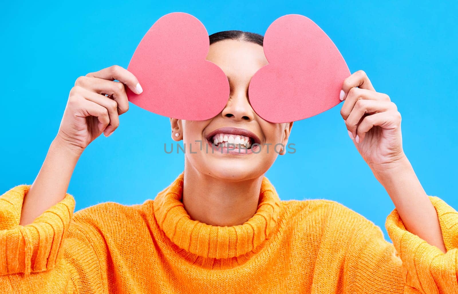 Heart eyes, cover and woman with happiness and excited about love, valentines day or emoji. Happy, smile and person with isolated blue background, loving or creative romance paper symbol to show care.