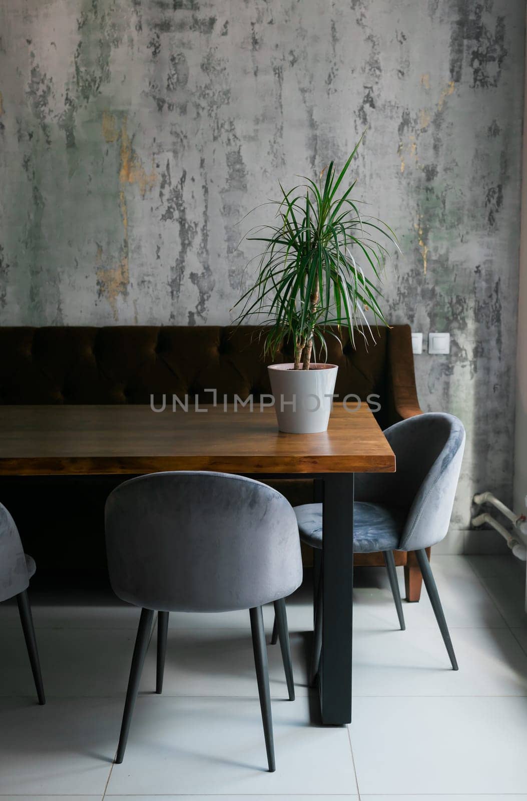 Grey chairs at wooden table in minimalist in cafe interior with poster and window