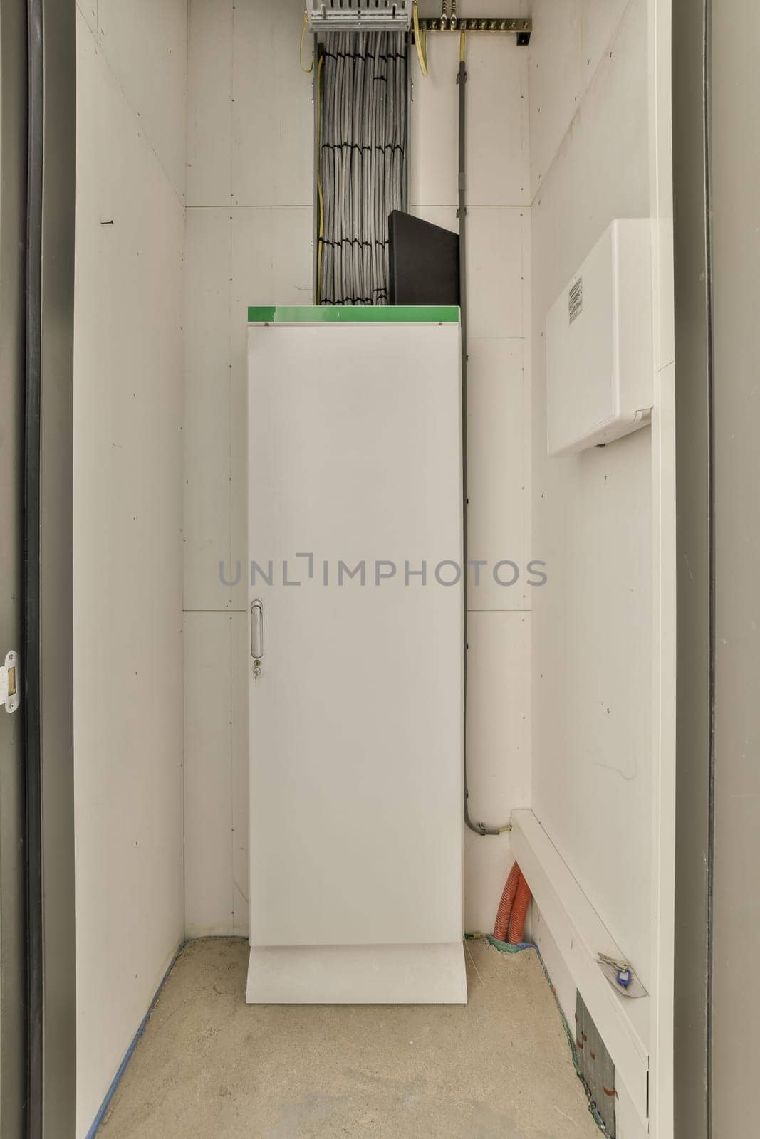 a white refrigerator freezer in the corner of a room that is being remodeled and ready to be used for storage