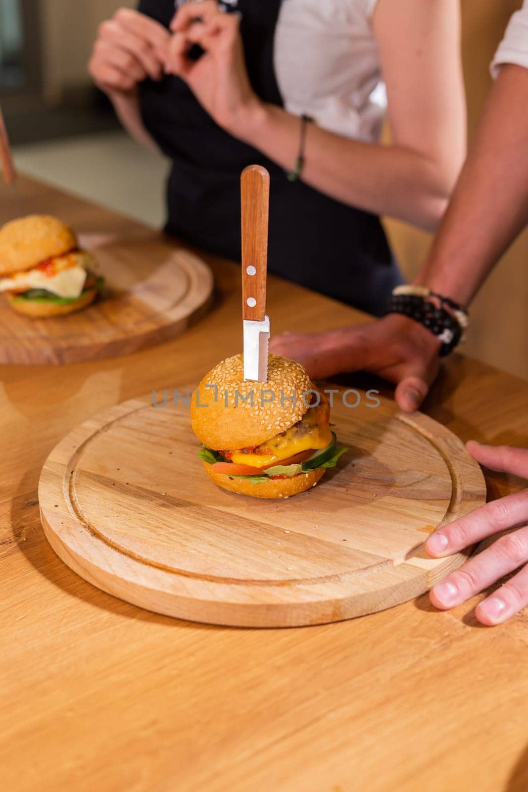 Beef burgers on wooden desk. Fat unhealthy food close-up by Satura86
