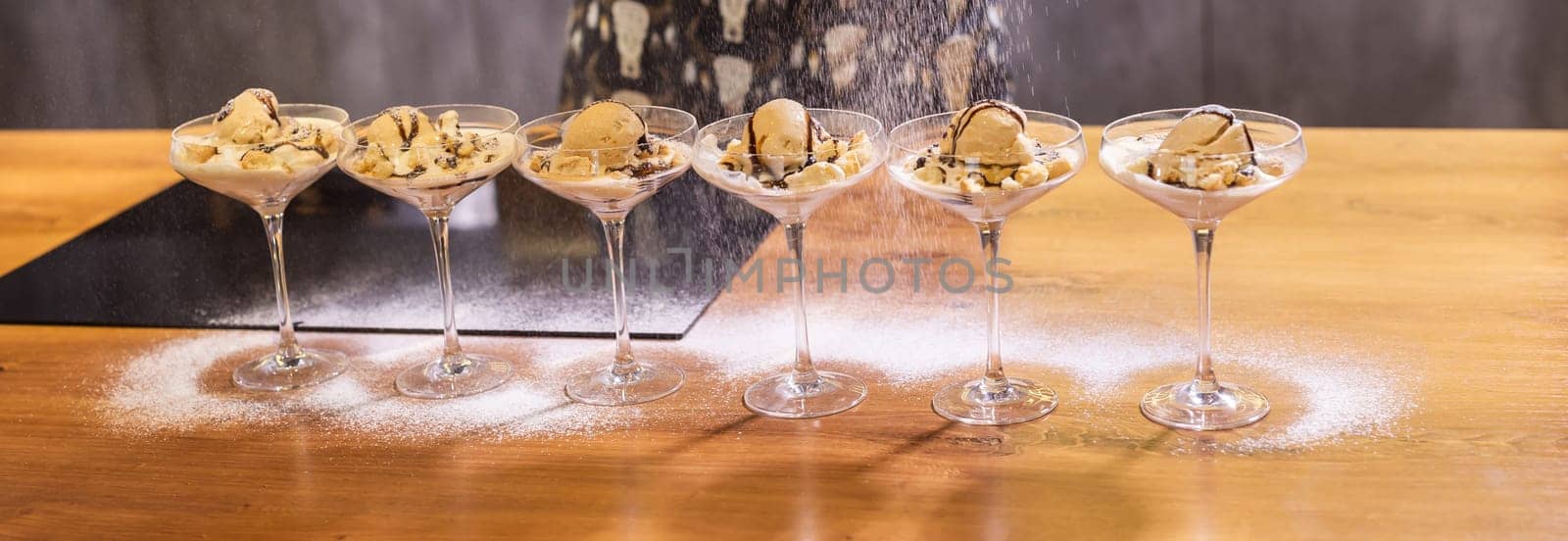 Tasty ice cream dessert made from chocolate and strawberry flavors with nuts and waffle cracker in glass bowl