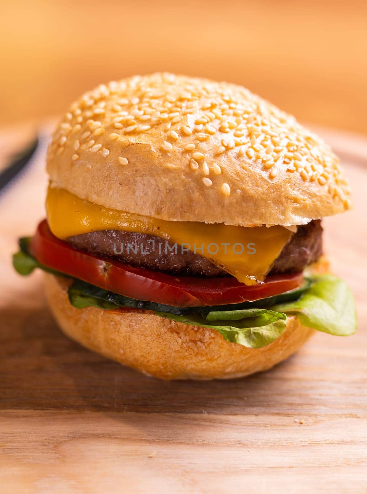 Beef burgers on wooden desk. Fat unhealthy food close-up by Satura86