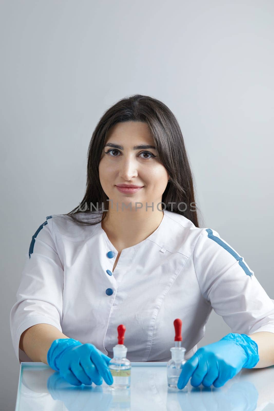 Doctor using pipette for taking samples for test in special chemical laboratory or clinic by Mariakray