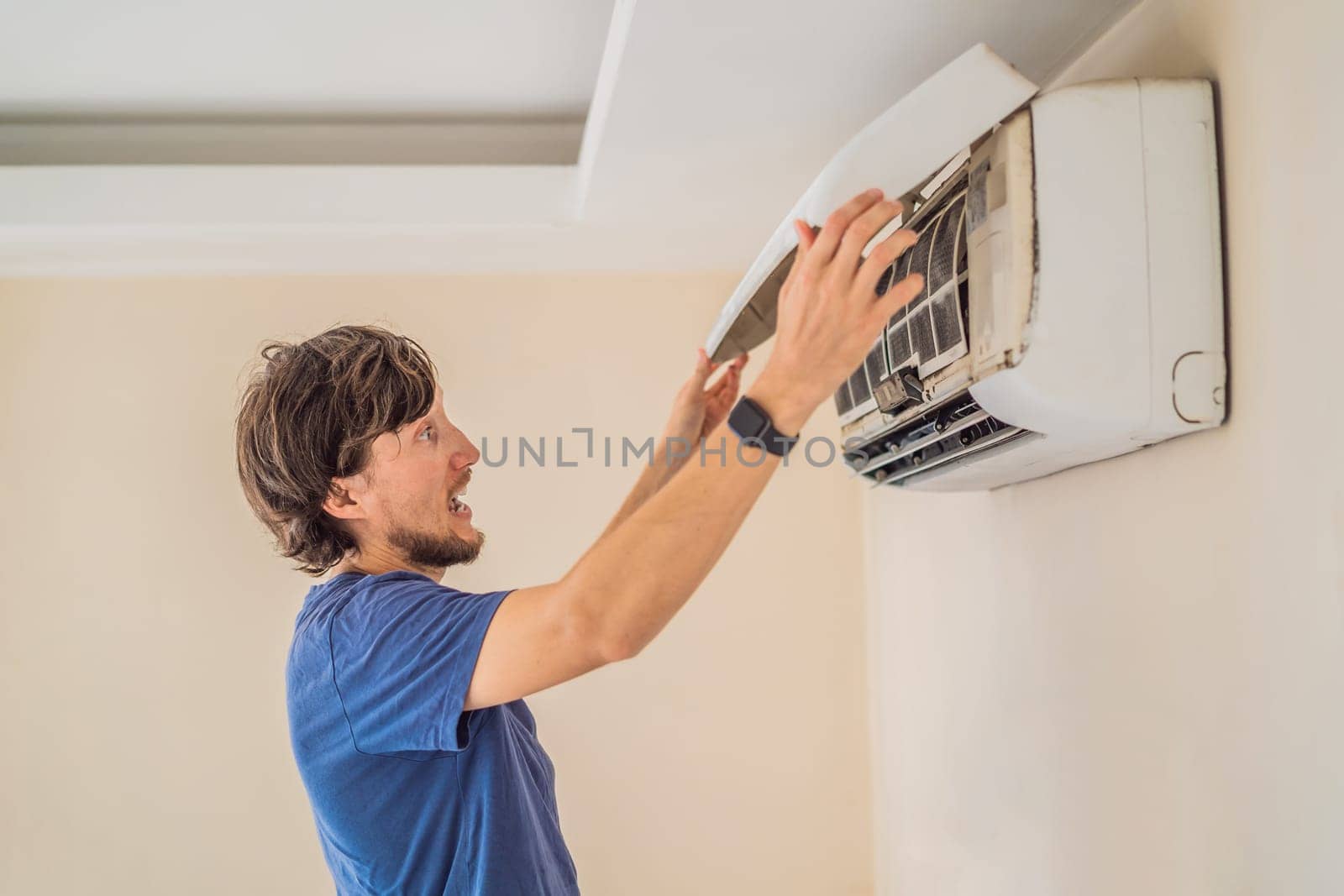 technician service removing air filter of the air conditioner for cleaning.